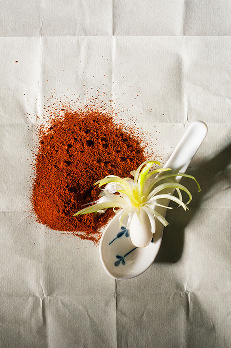 Food photographer, JP Bond's photo of paprika spread across a rustic background.
